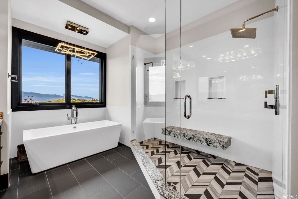 Bathroom featuring separate shower and tub and tile flooring