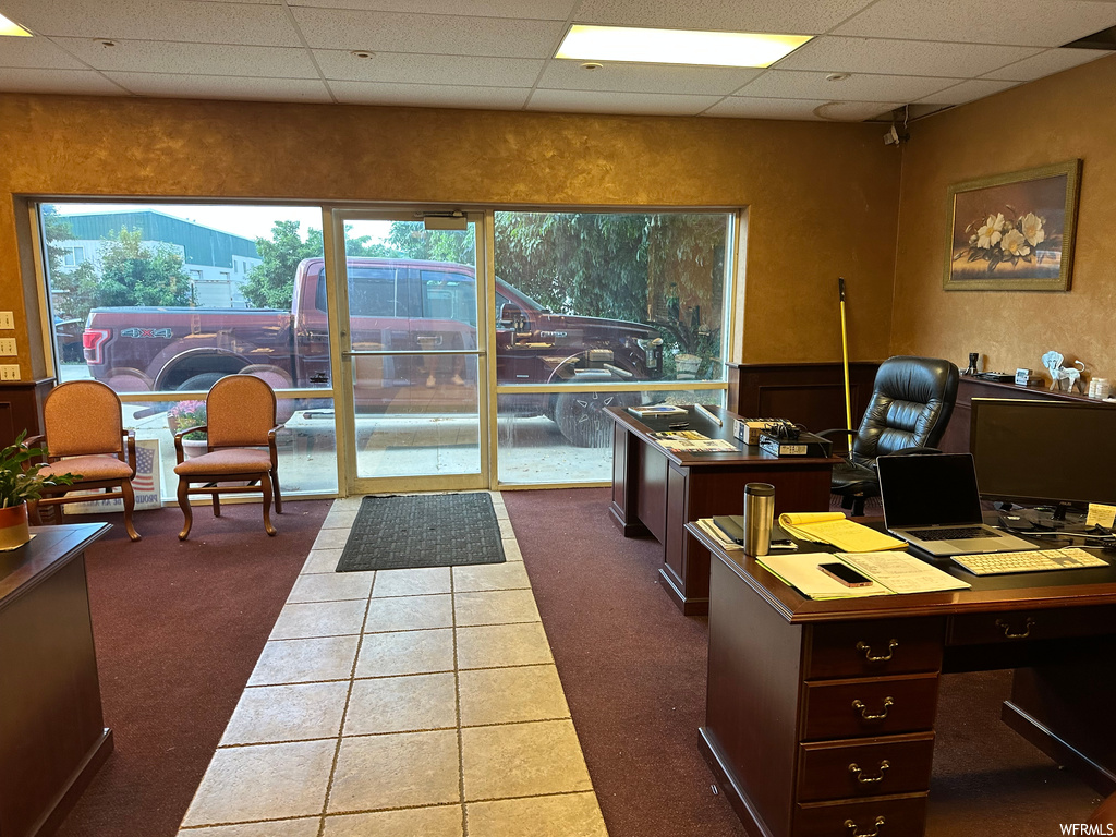 Carpeted office with a drop ceiling
