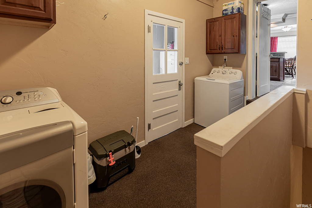 Laundry area with independent washer and dryer, cabinets, and carpet flooring