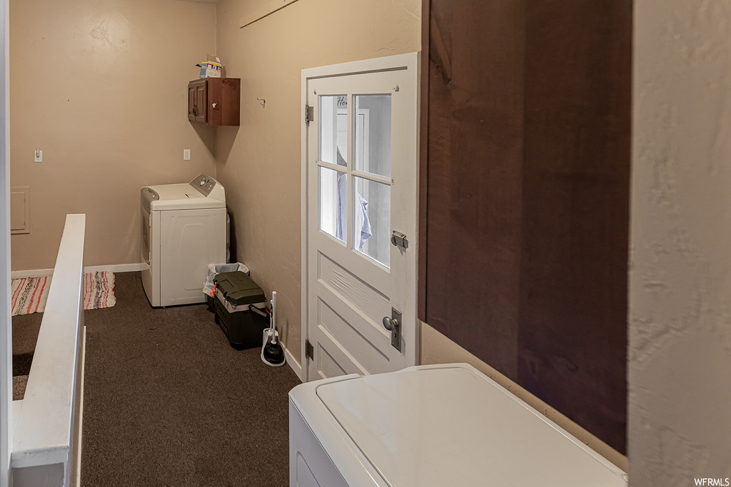 Washroom featuring independent washer and dryer, cabinets, and carpet flooring