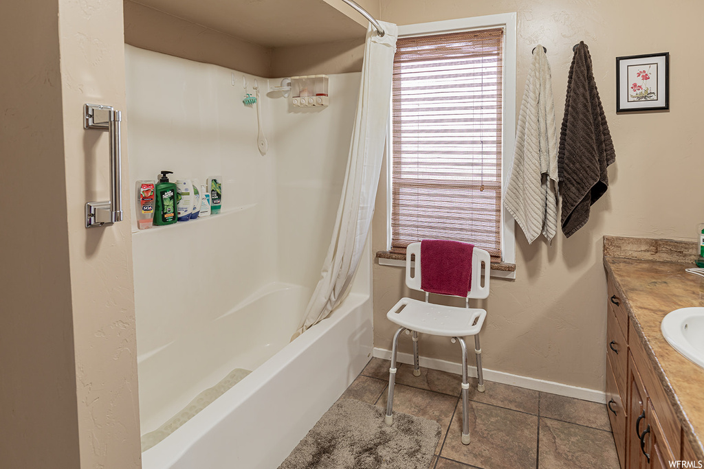 Bathroom featuring shower / bath combo, vanity, and tile floors