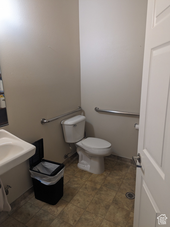 Bathroom featuring tile floors and toilet