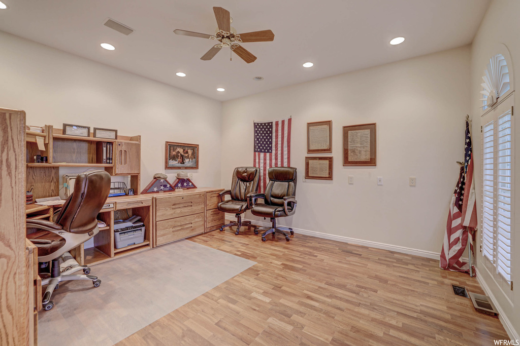 Office with ceiling fan and light hardwood flooring