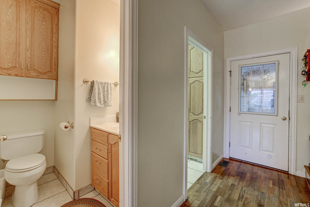 Bathroom featuring vanity and light hardwood flooring