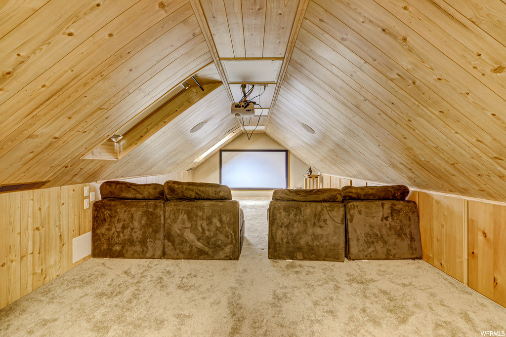 Bonus room with wood walls, vaulted ceiling, wood ceiling, and light carpet