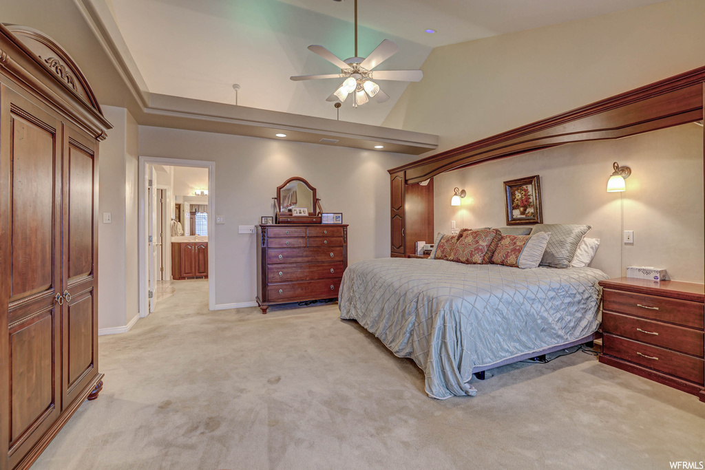 Carpeted bedroom featuring vaulted ceiling, ceiling fan, and a high ceiling