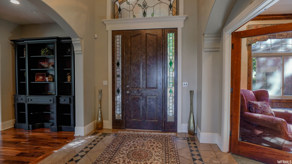 Wood floored entrance foyer featuring a wealth of natural light