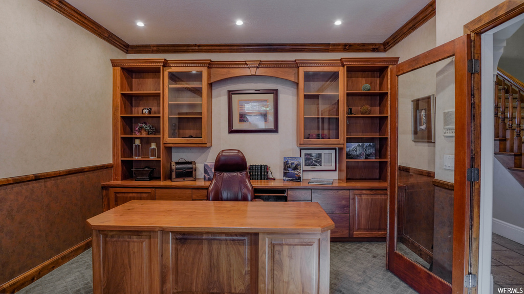 Office area with dark carpet and ornamental molding