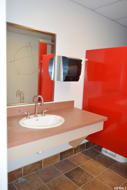 Bathroom with oversized vanity, tile floors, and mirror