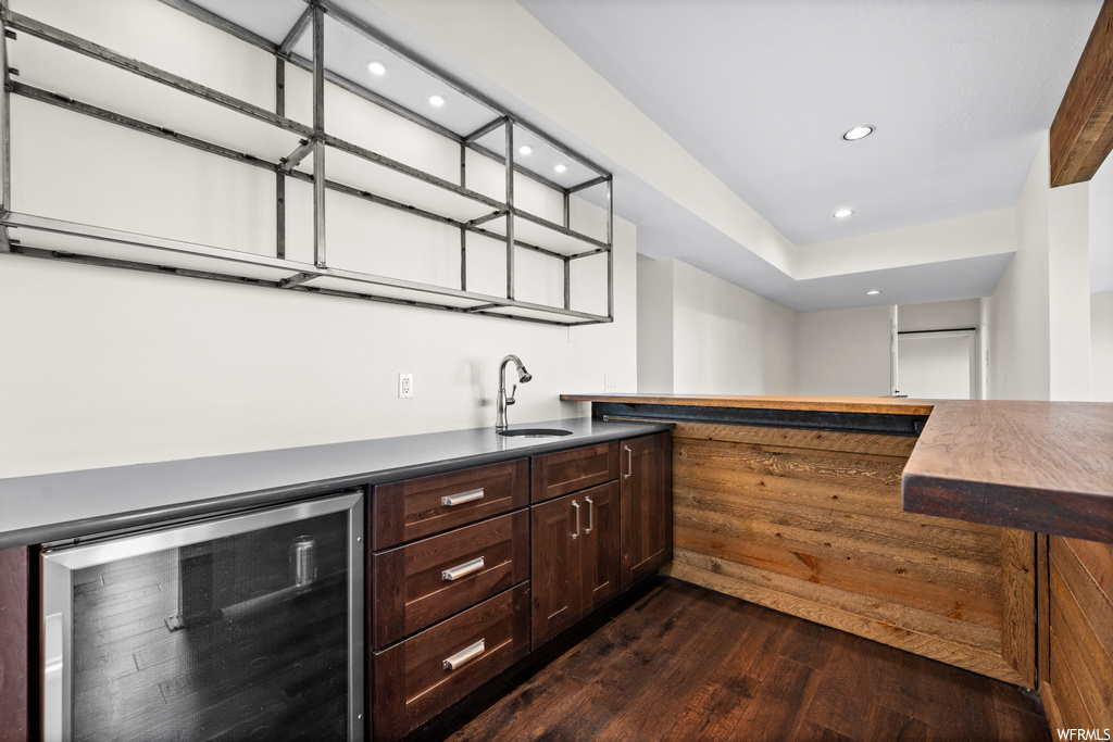Kitchen with dark hardwood flooring and dark brown cabinetry