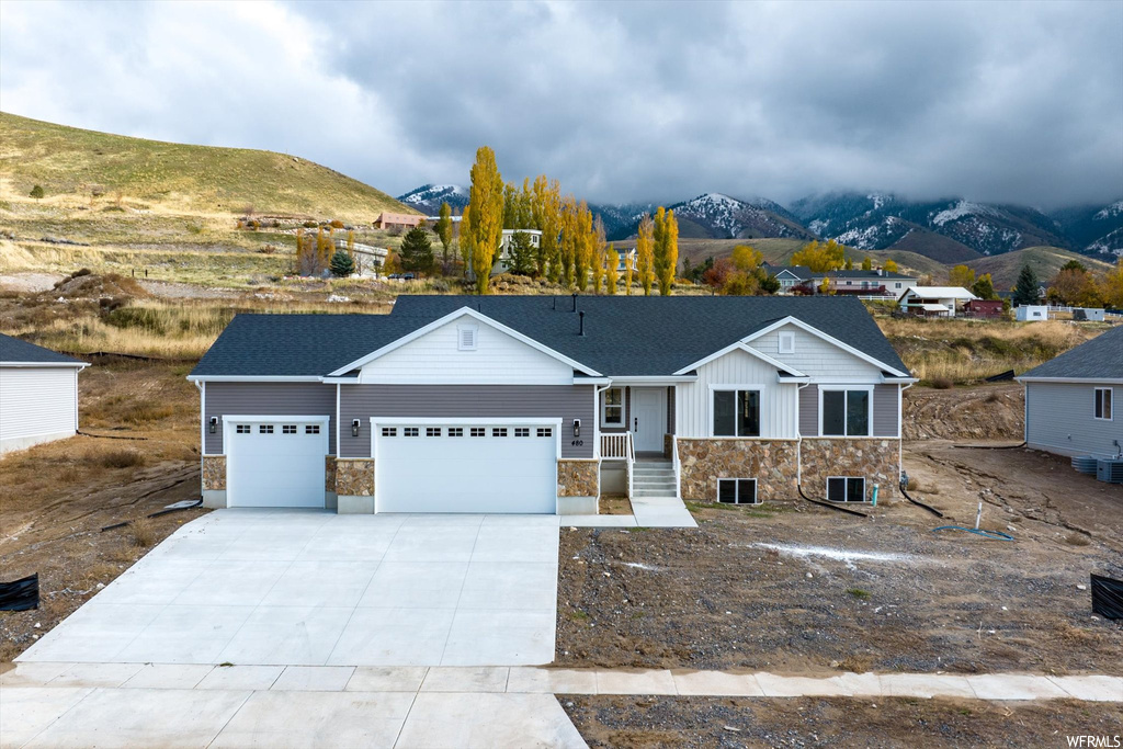 View of front of house featuring a garage and a mountain view