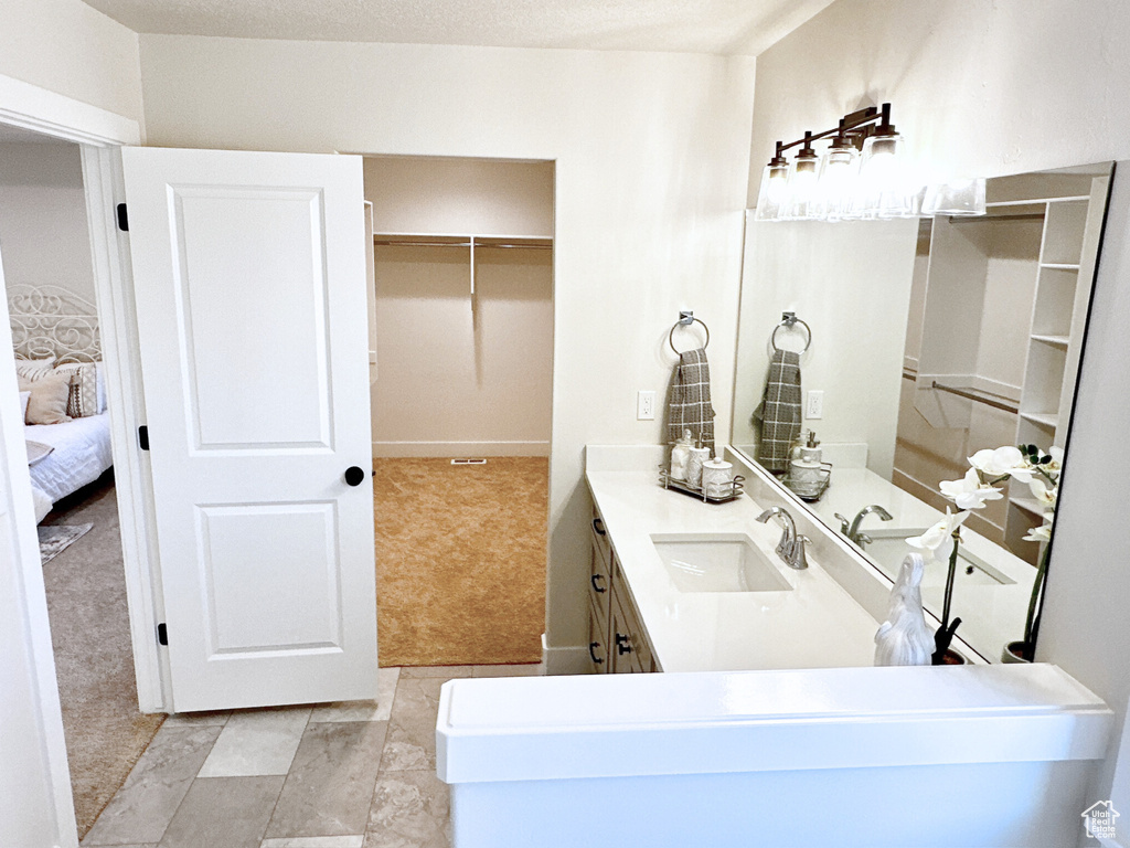 Bathroom featuring vanity and tile patterned floors