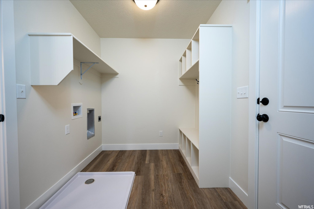 Laundry room with washer hookup, hookup for an electric dryer, and dark hardwood / wood-style flooring