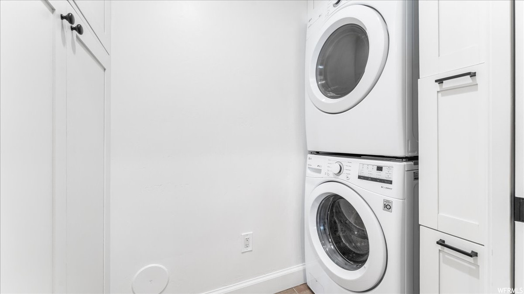 Laundry room featuring stacked washer and dryer