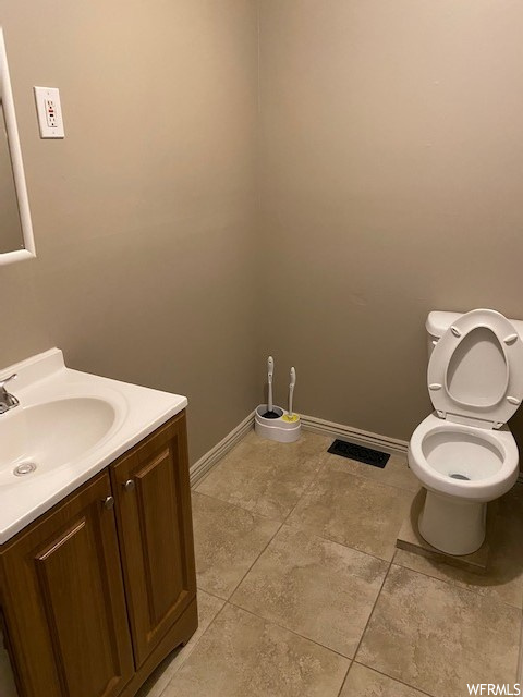 Bathroom with vanity and light tile flooring