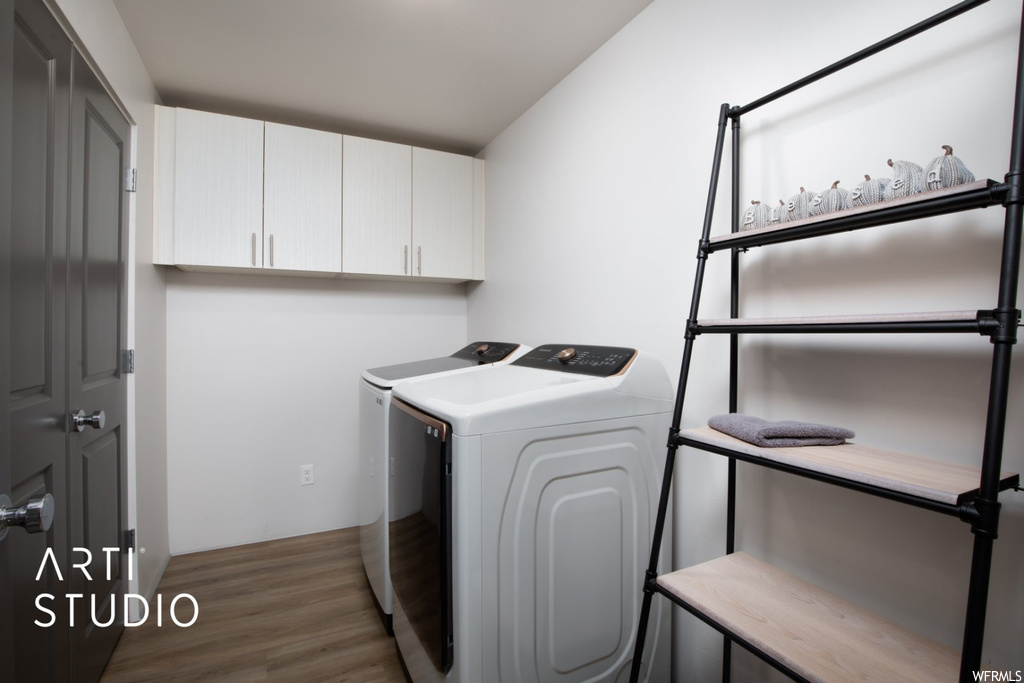 Clothes washing area featuring dark hardwood flooring and washer / dryer