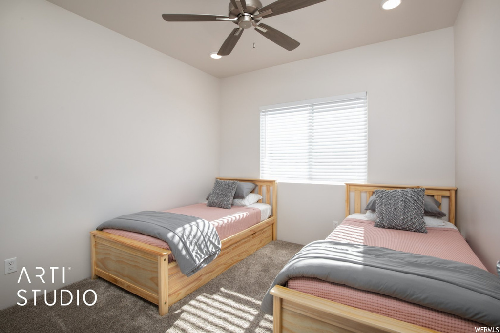 Carpeted bedroom with ceiling fan