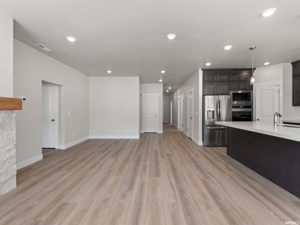 Hardwood floored living room featuring a textured ceiling