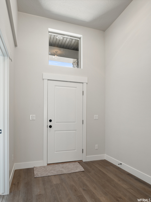 Wood floored foyer entrance with a wealth of natural light