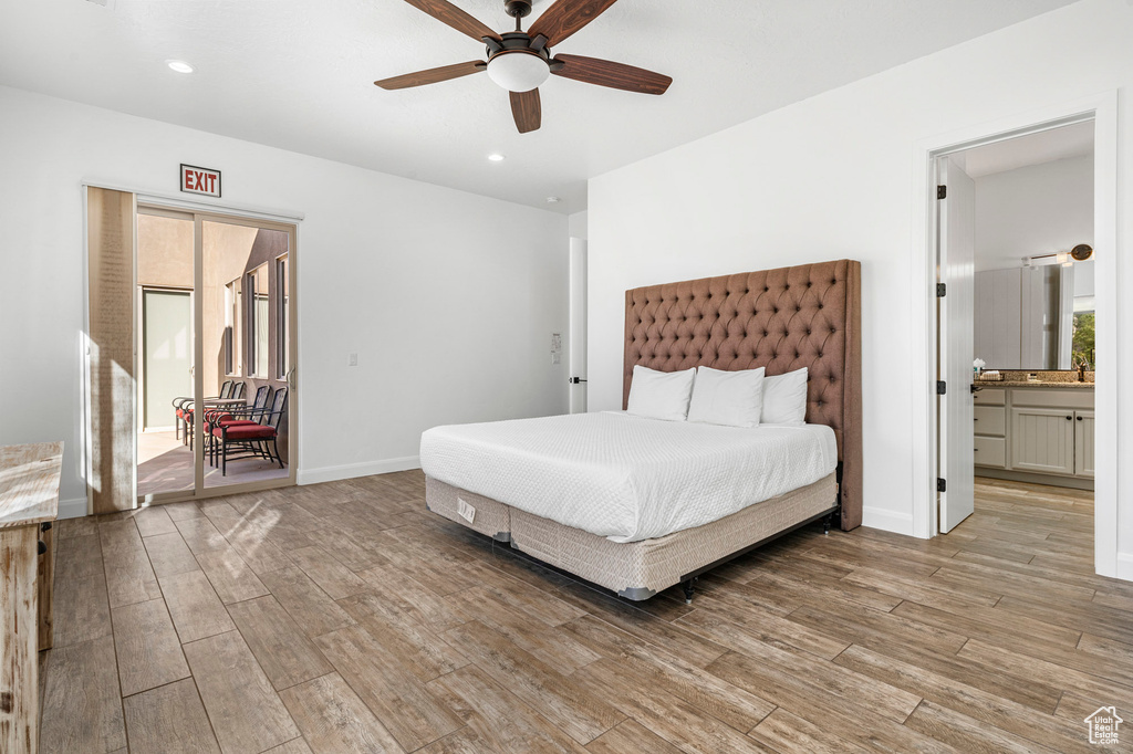 Bedroom featuring ensuite bathroom, light hardwood / wood-style flooring, and ceiling fan