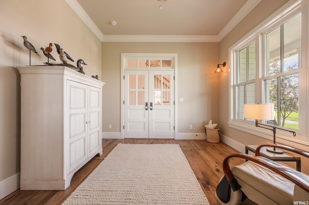 Interior space featuring light hardwood flooring and ornamental molding
