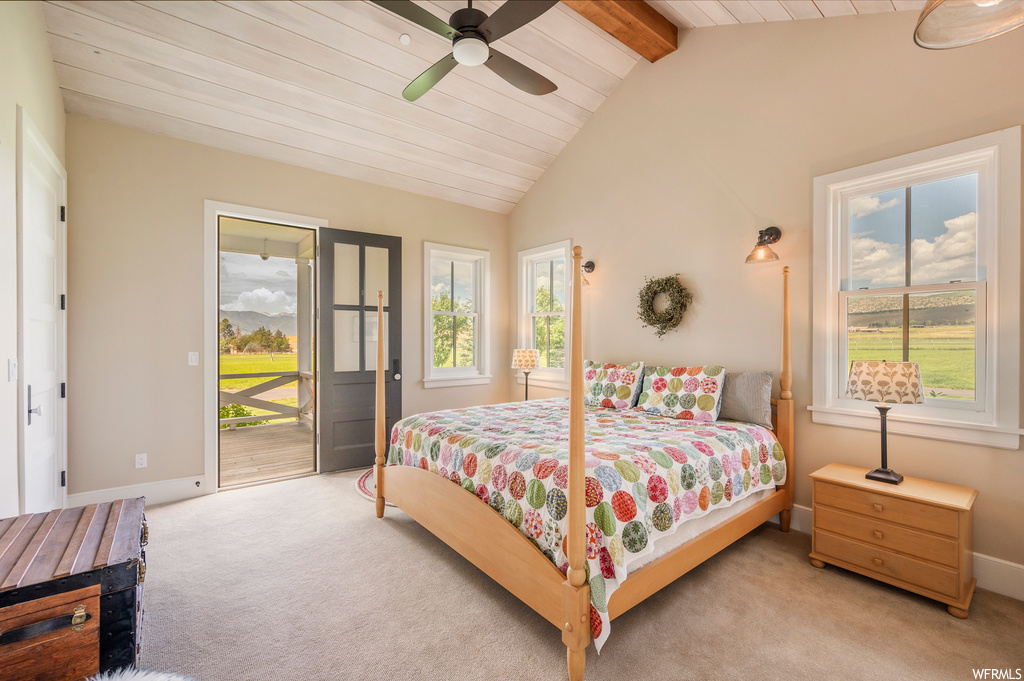 Bedroom featuring ceiling fan, light carpet, and vaulted ceiling with beams