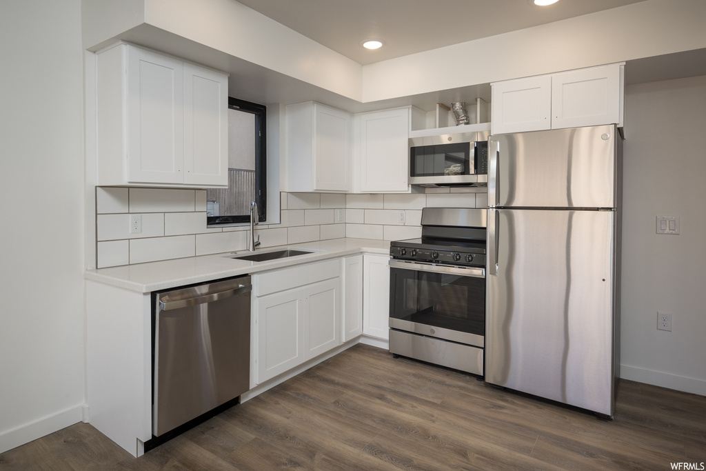 Kitchen featuring white cabinetry, sink, and appliances with stainless steel finishes