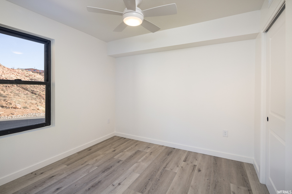 Spare room featuring light wood-type flooring and ceiling fan