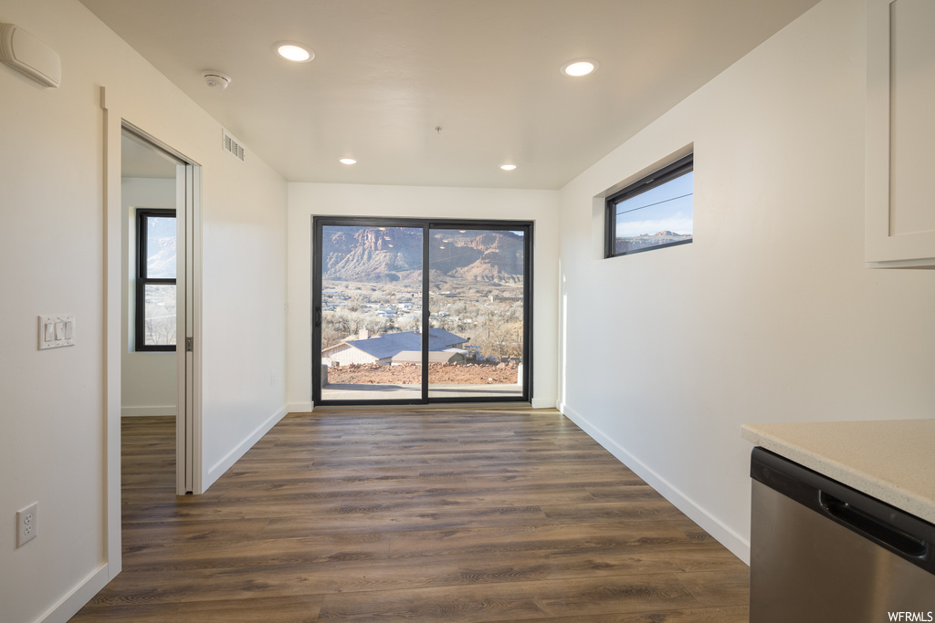 Interior space featuring dark hardwood / wood-style floors and plenty of natural light