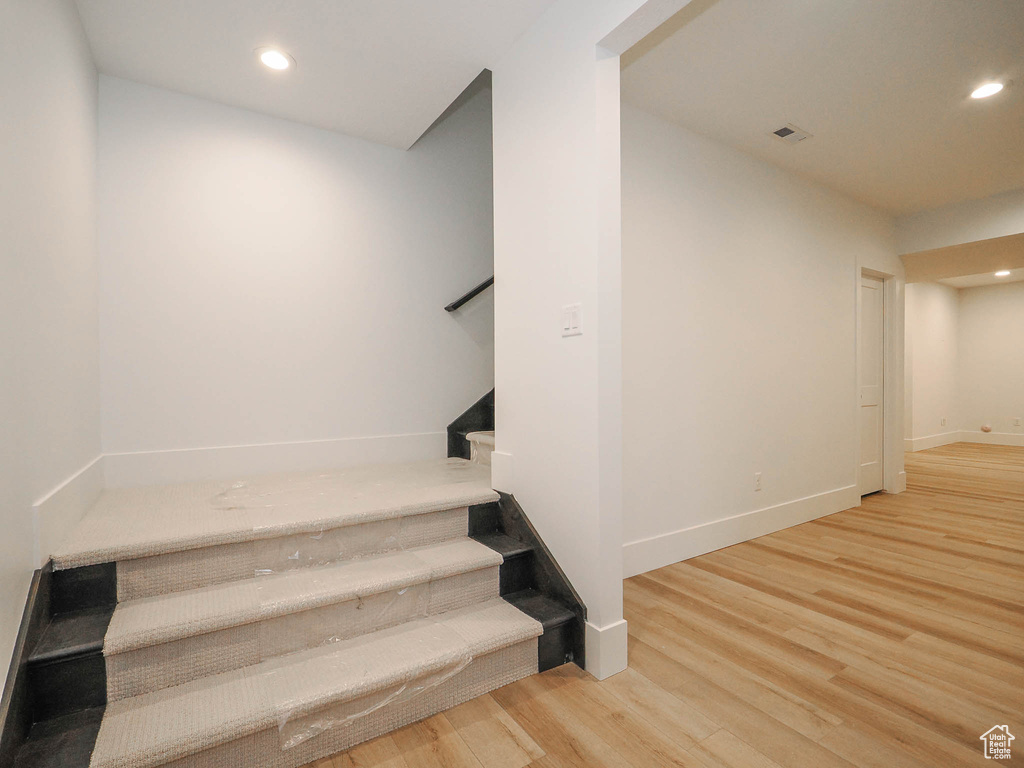 Stairs featuring light hardwood / wood-style flooring