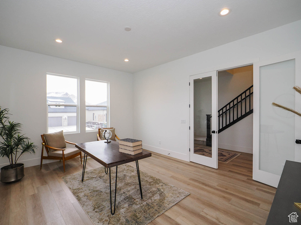 Sitting room with light hardwood / wood-style flooring