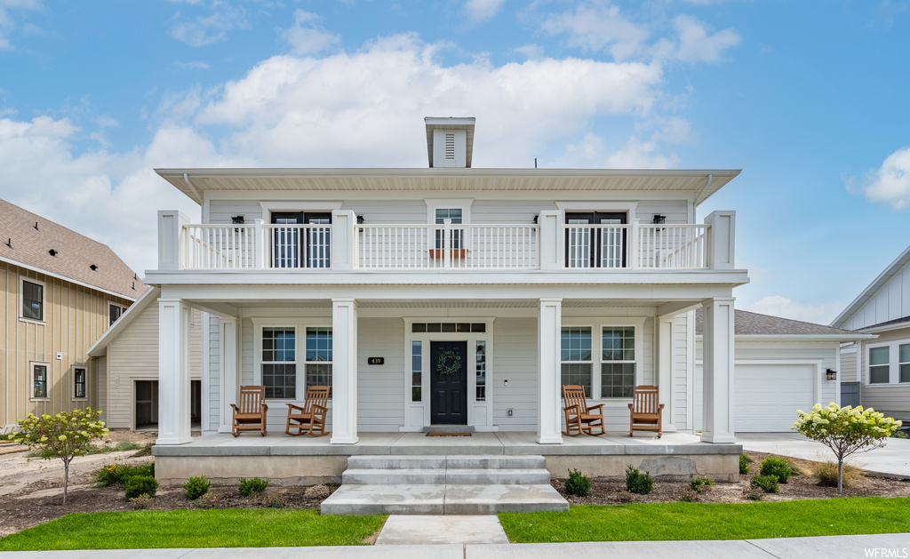 View of front of home featuring balcony