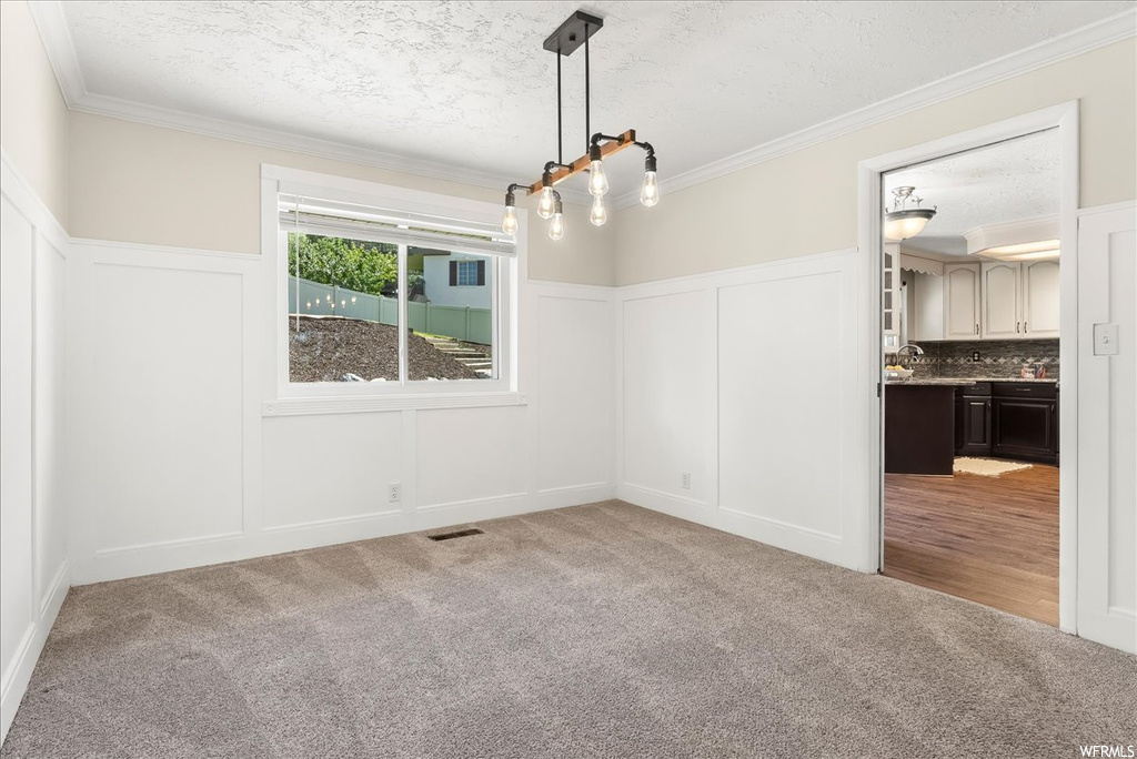 Empty room with light carpet and ornamental molding