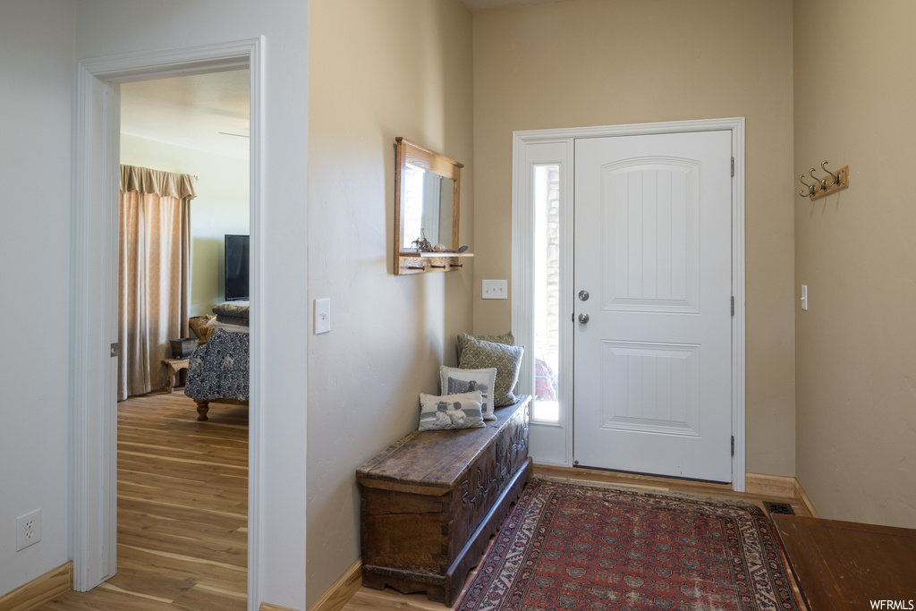 Entryway with light hardwood flooring