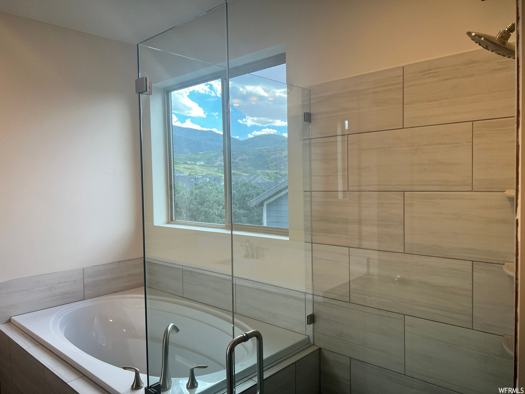 Bathroom featuring independent shower and bath