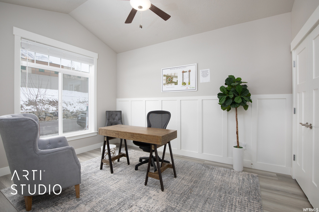 Office with ceiling fan, light hardwood floors, and lofted ceiling
