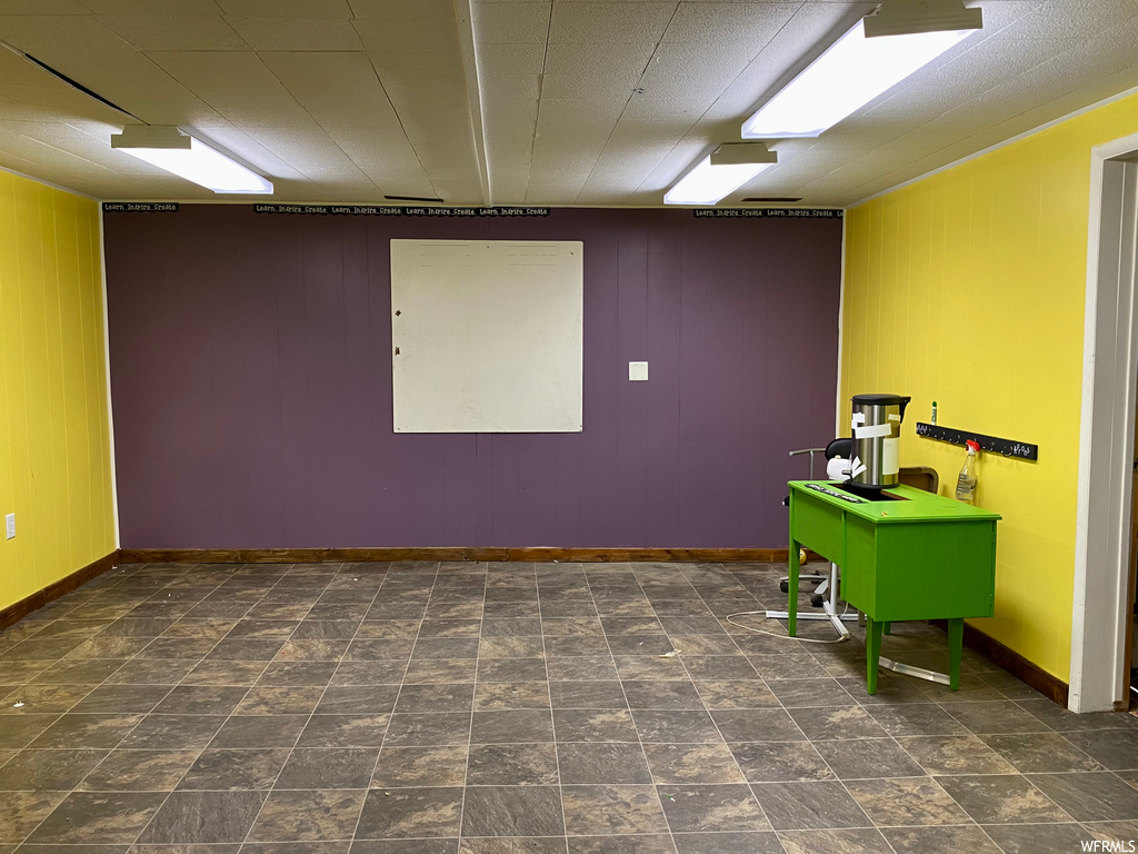 Home office with dark tile flooring