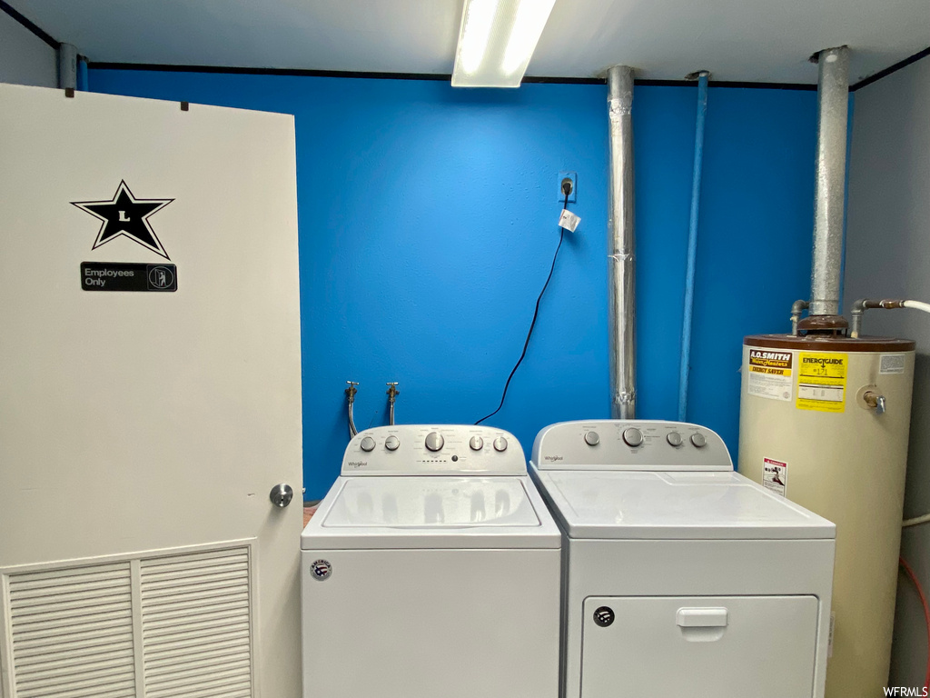 Laundry area featuring water heater and washer and dryer