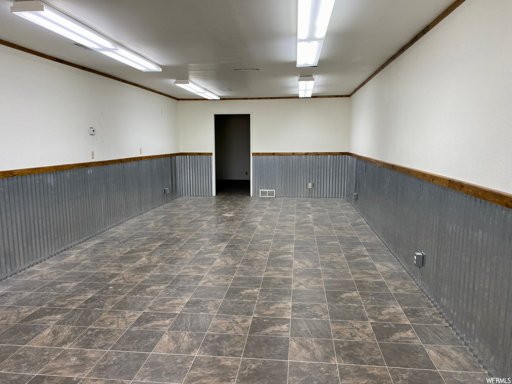 Basement with dark tile floors