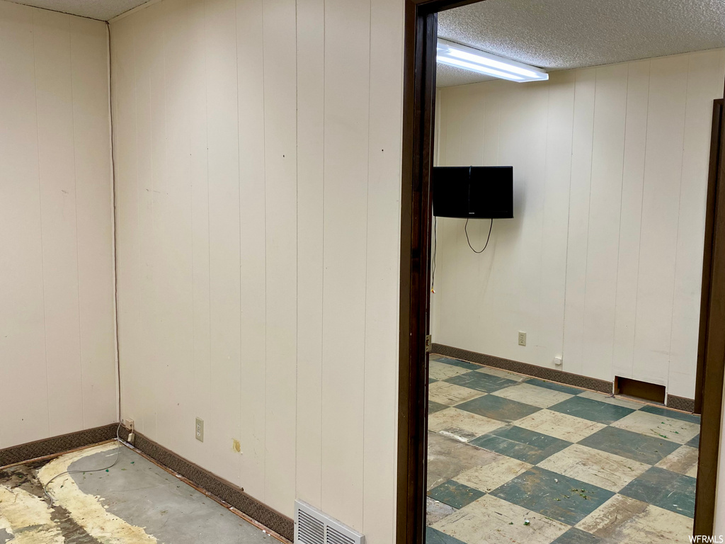 Unfurnished room with a textured ceiling