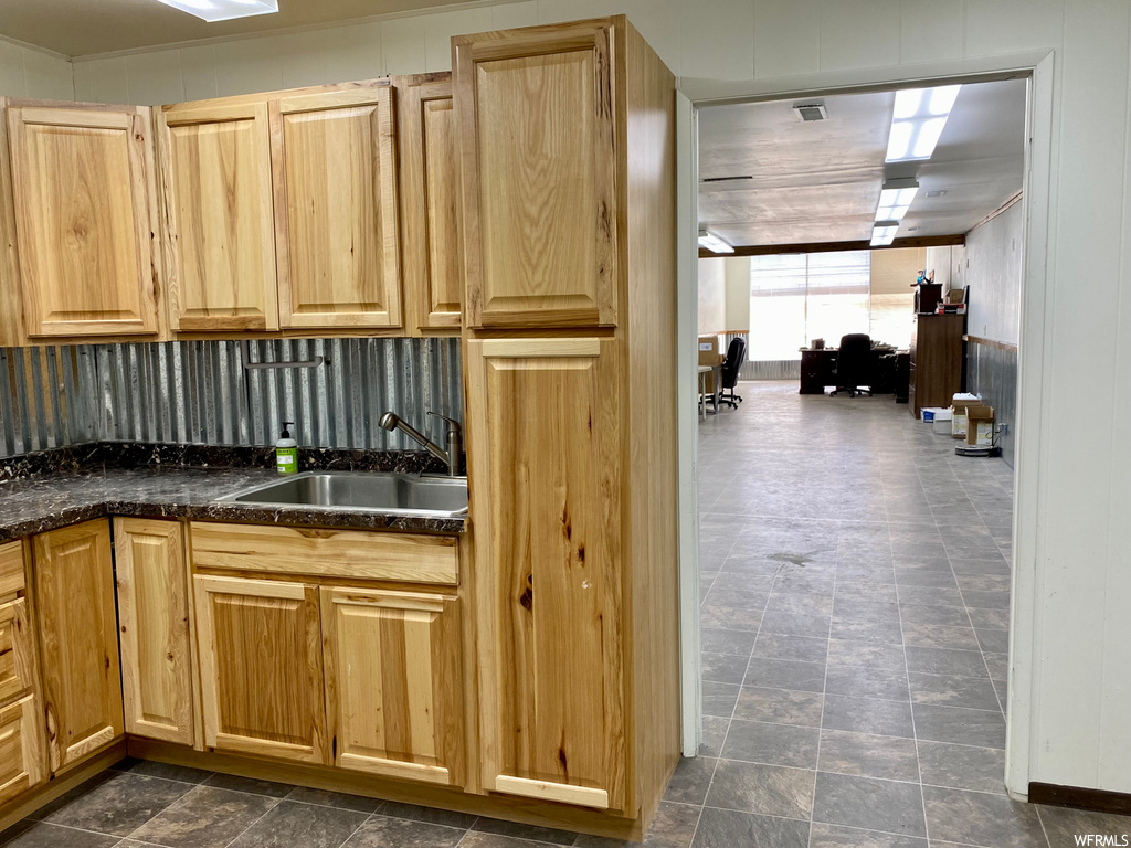 Kitchen featuring dark tile flooring and dark countertops