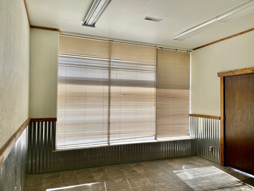 Unfurnished room featuring dark tile flooring