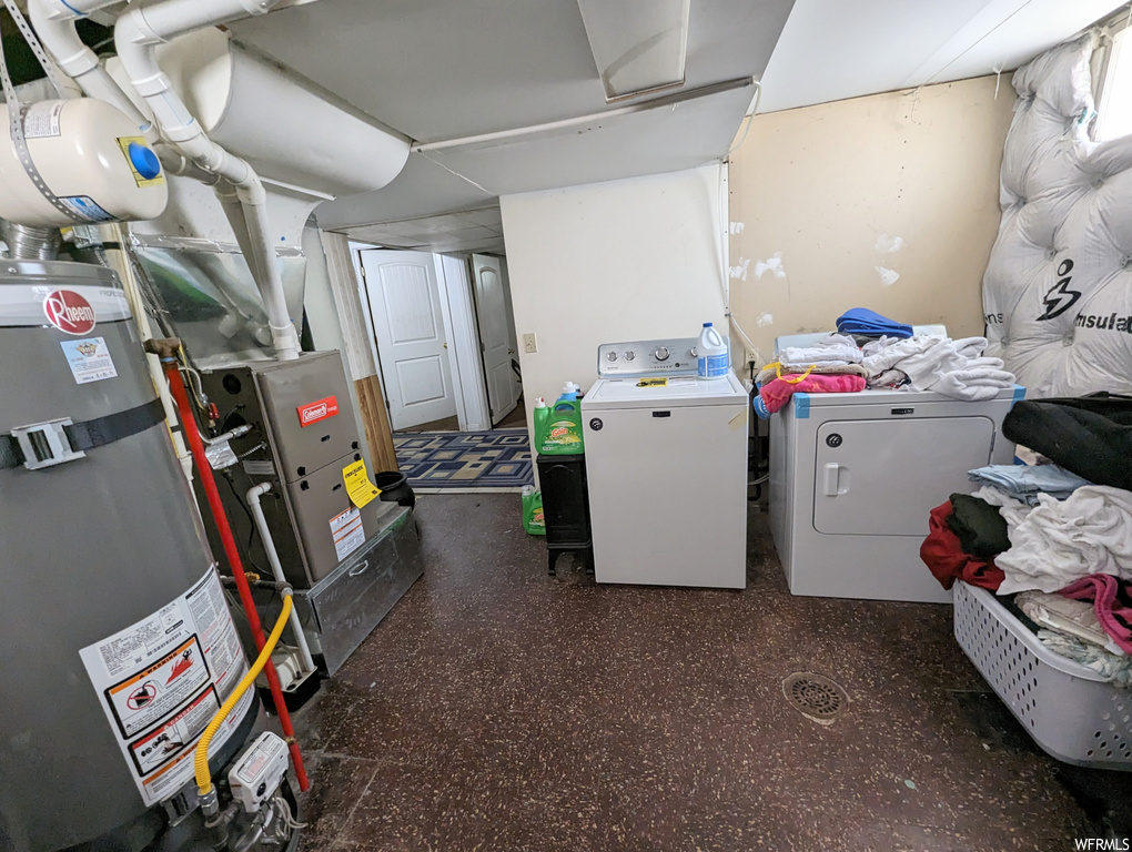 Laundry room featuring washing machine and dryer and gas water heater