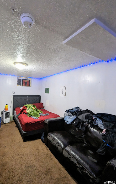 Bedroom featuring a textured ceiling and carpet