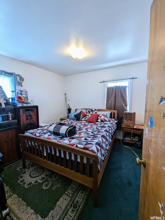 Bedroom featuring dark carpet