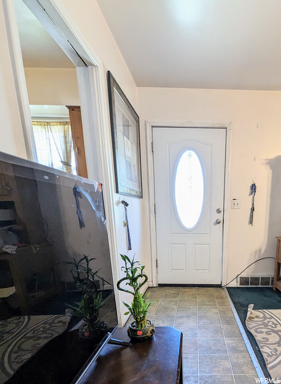 Foyer featuring light tile floors