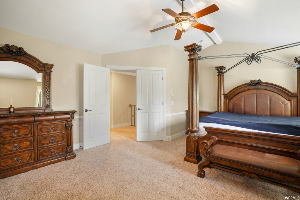 Bedroom featuring light carpet, lofted ceiling, and ceiling fan