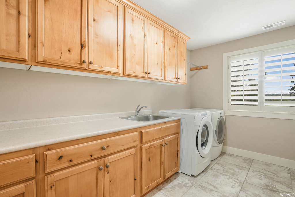Laundry area featuring washer / clothes dryer, washer and dryer, and light tile floors