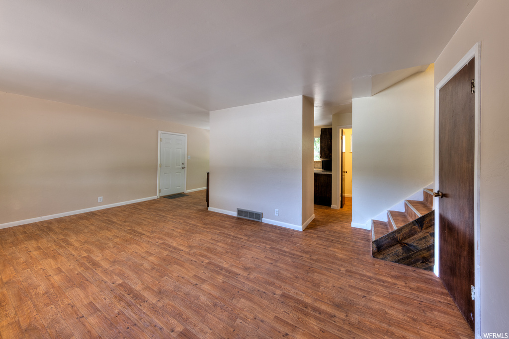 Spare room featuring hardwood floors