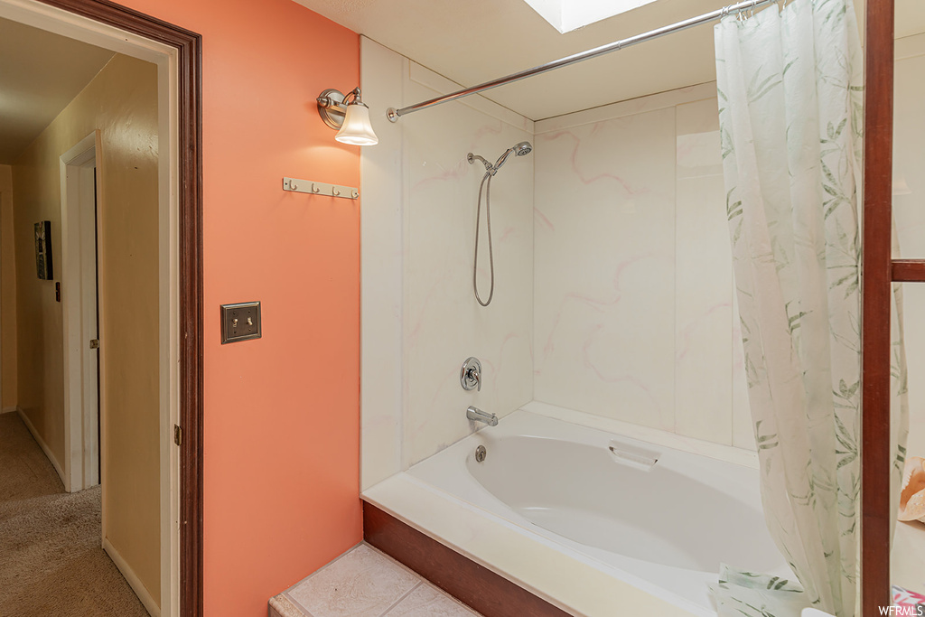 Bathroom with shower / bath combo with shower curtain